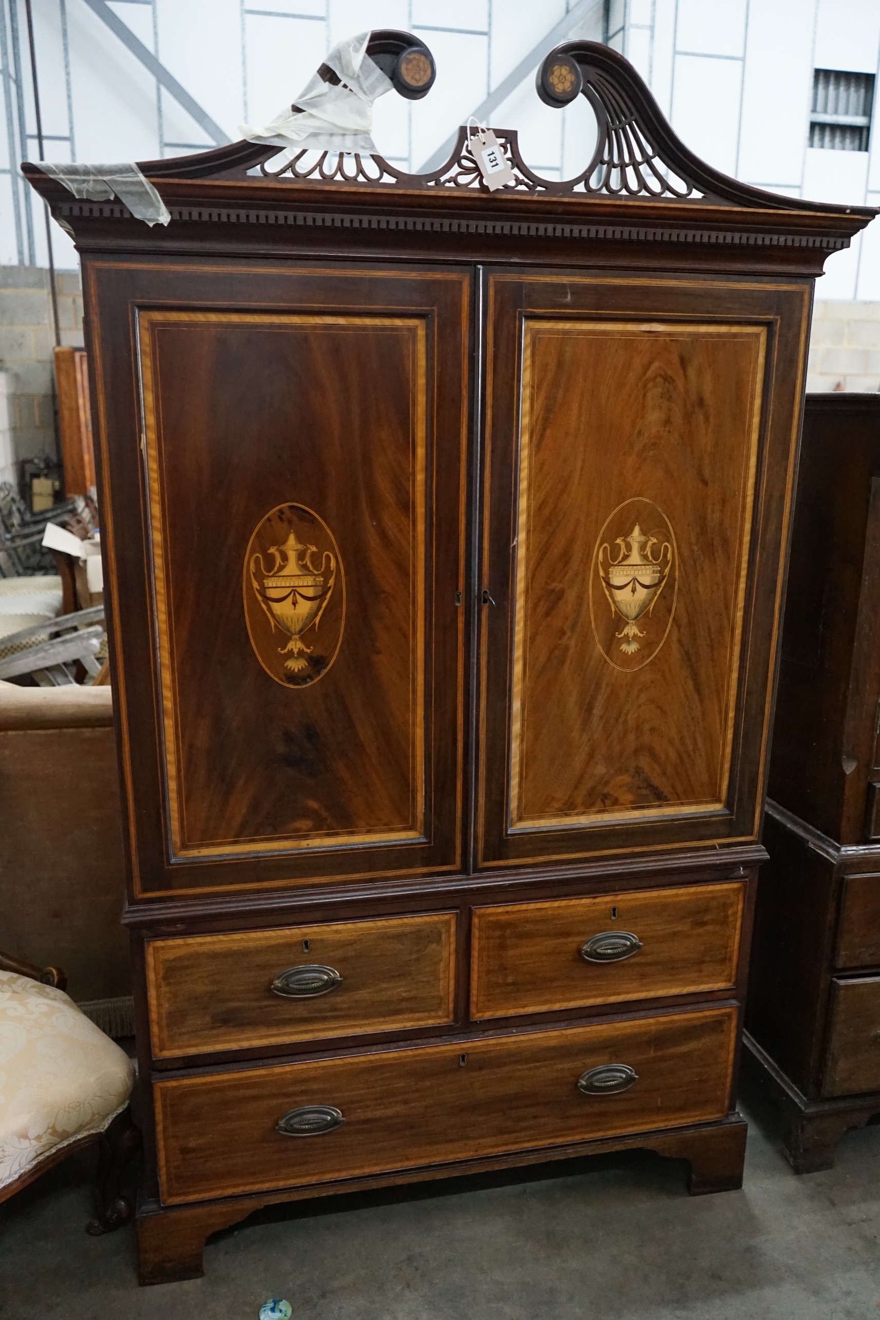 A small George III style inlaid mahogany linen press, width 116cm, depth 59cm, height 186cm